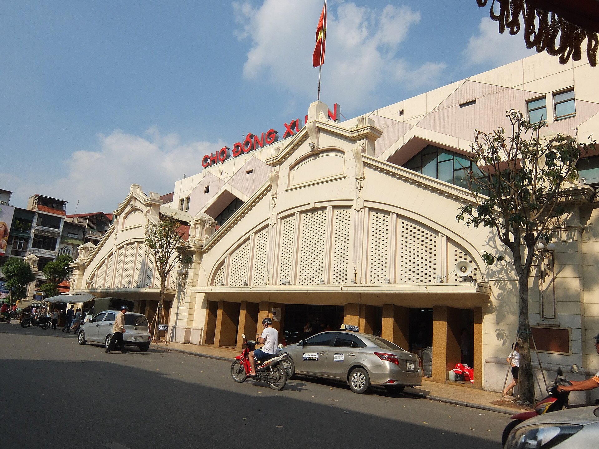 The market building seen from the street with motorbikes parked outside
