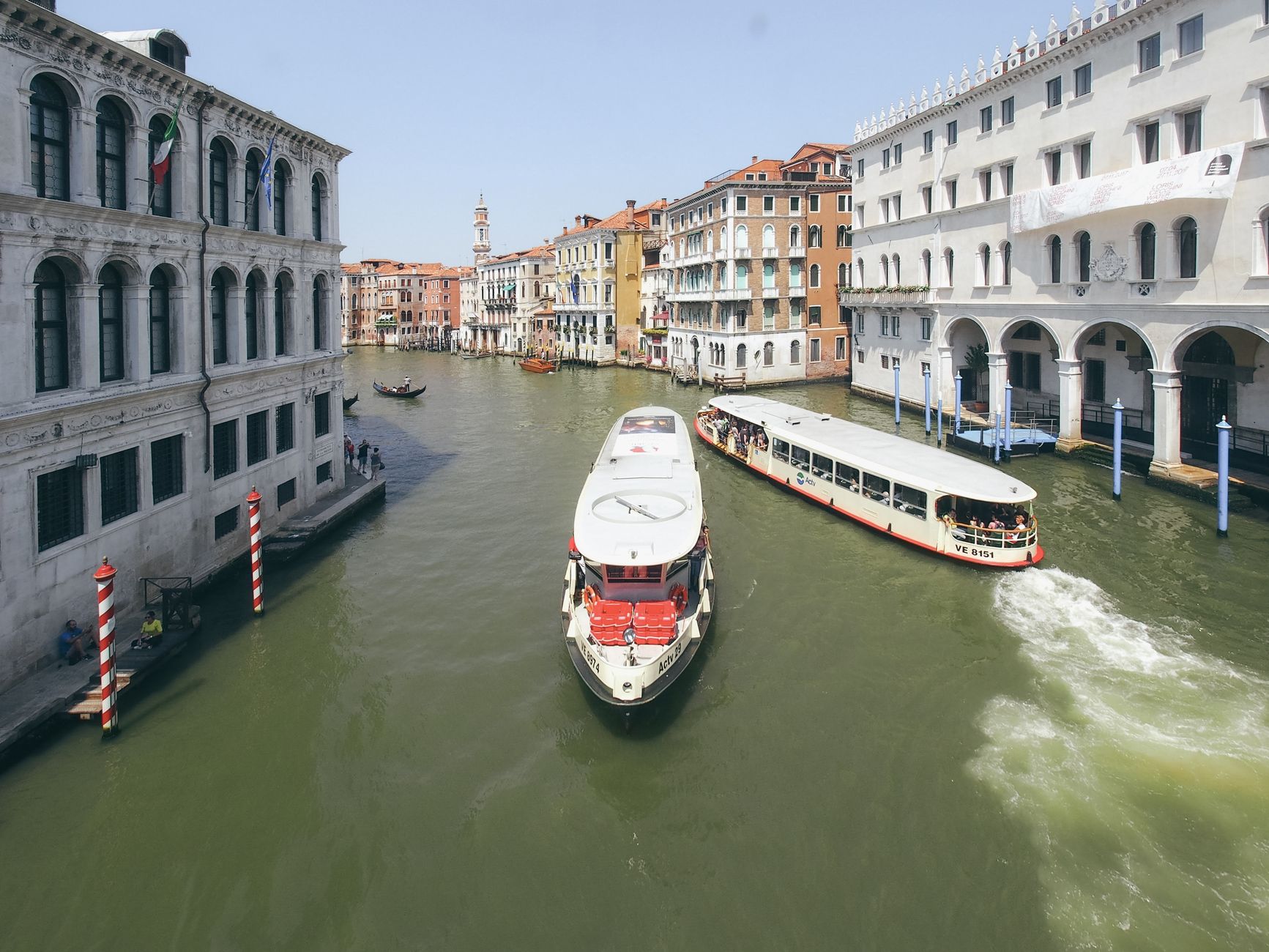 Explore the Canal Grande in Venice with boats navigating historic waters surrounded by architecture