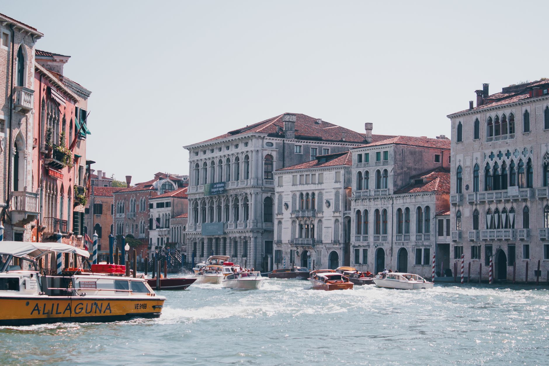 Experience the historic charm of Venice with motorboats weaving through Canal Grande
