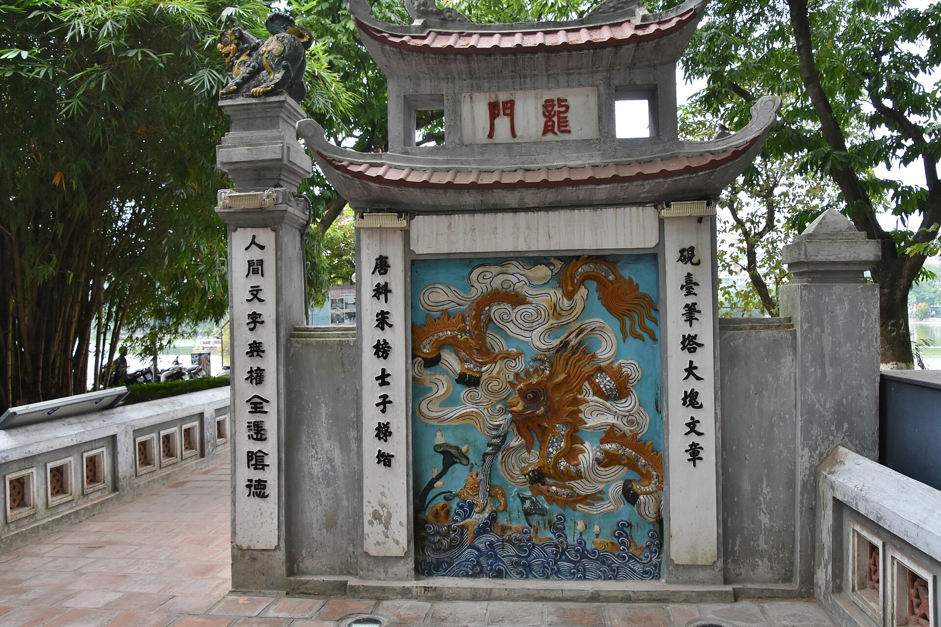 The ornate entrance gate to Ngoc Son Temple with its painted panels