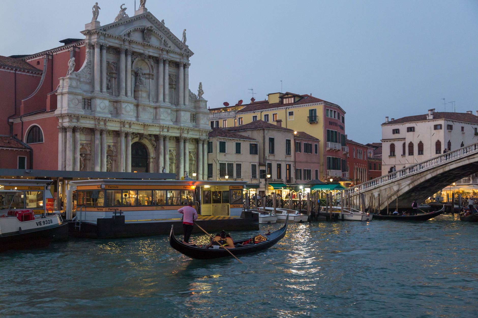 Gondola on a Venice canal near a historic building at dusk