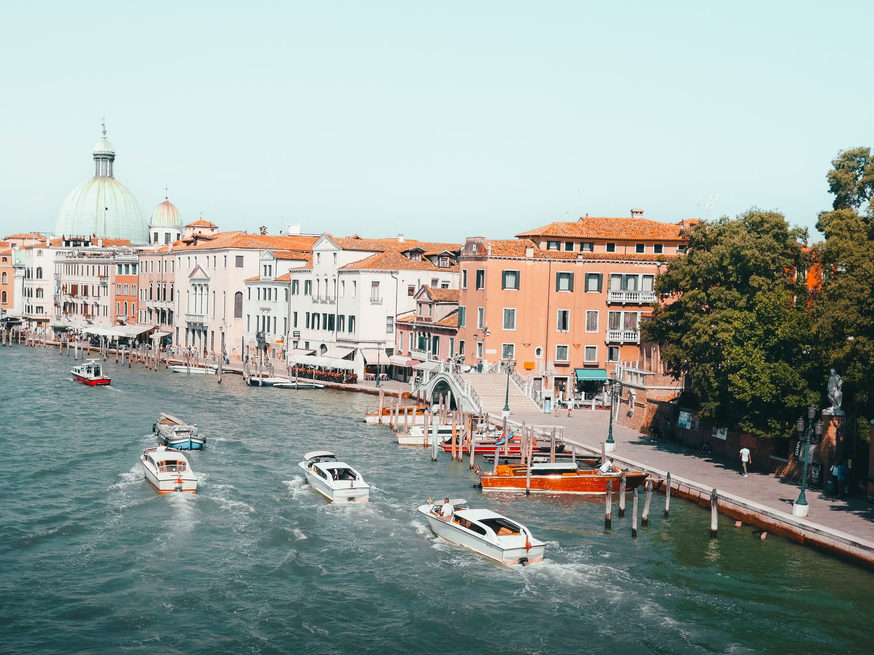 Venice's Grand Canal with boats and historic buildings, showcasing the city's unique charm