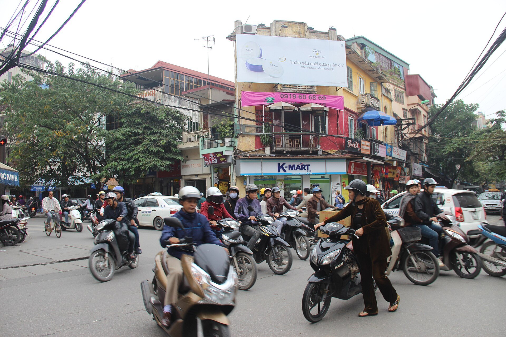 Hang Gai street with shopfronts and overhead cables