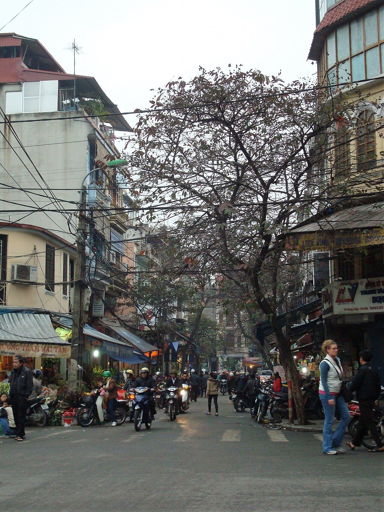 A street in the Old Quarter with motorbikes and shopfronts