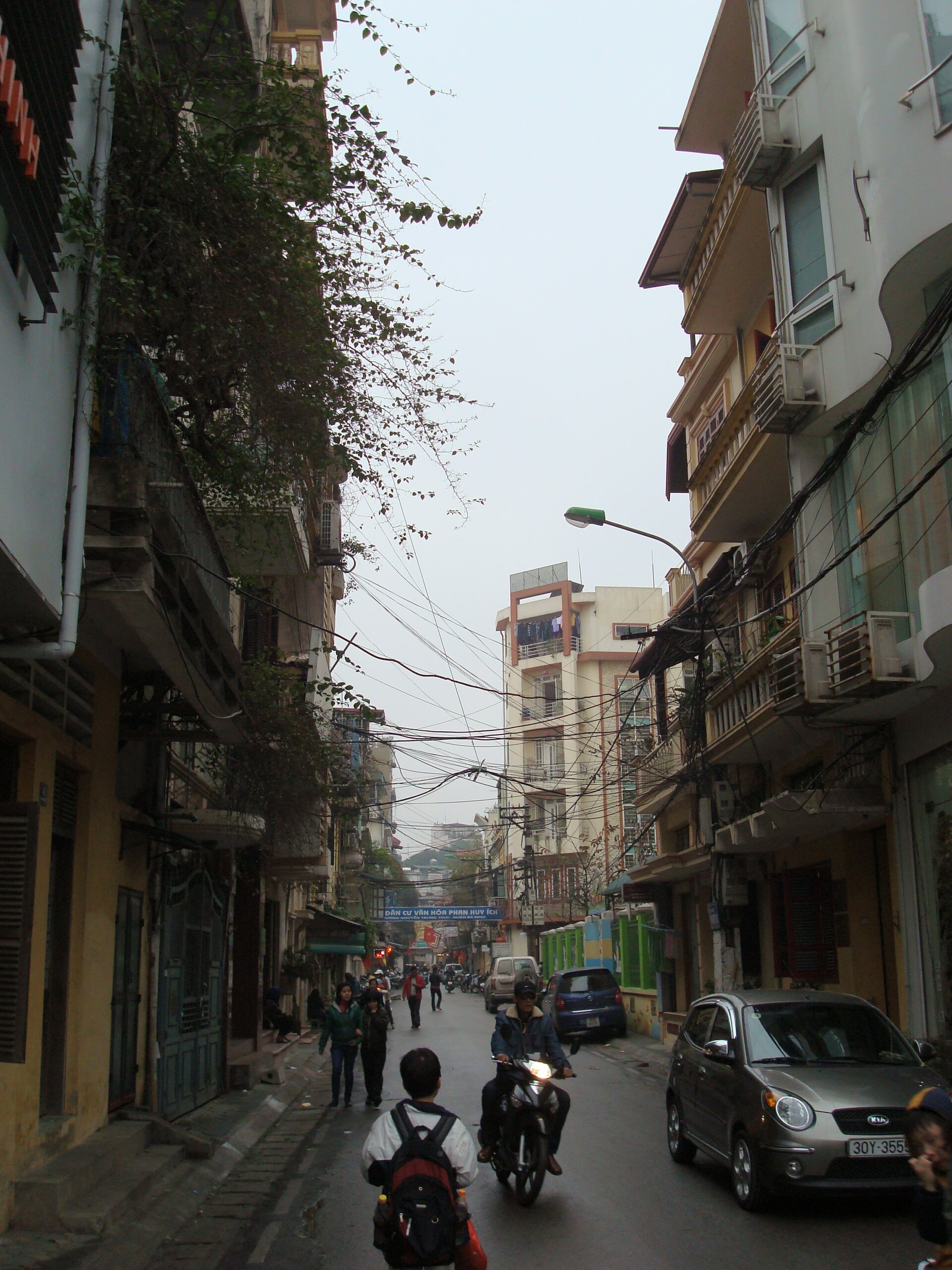 A narrow Old Quarter street lined with tall shophouses