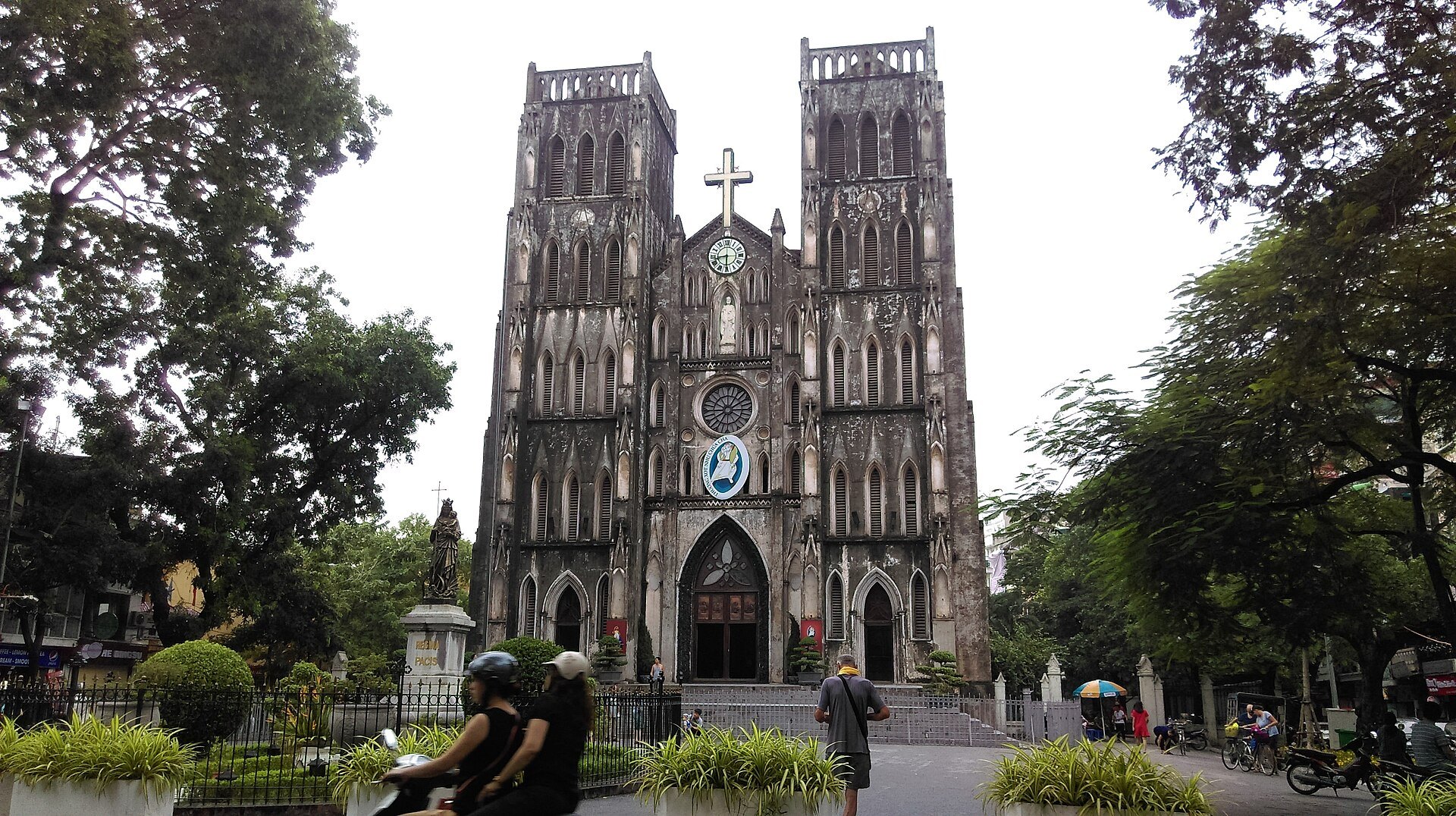 The cathedral front framed by trees
