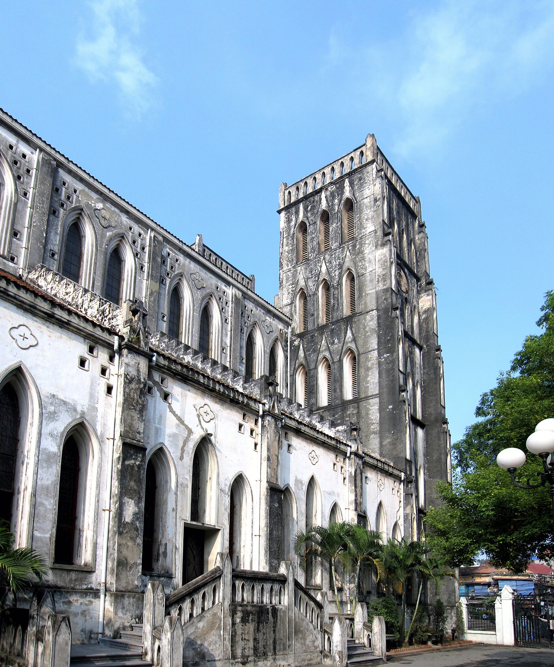 The weathered grey stone of the cathedral against a bright sky