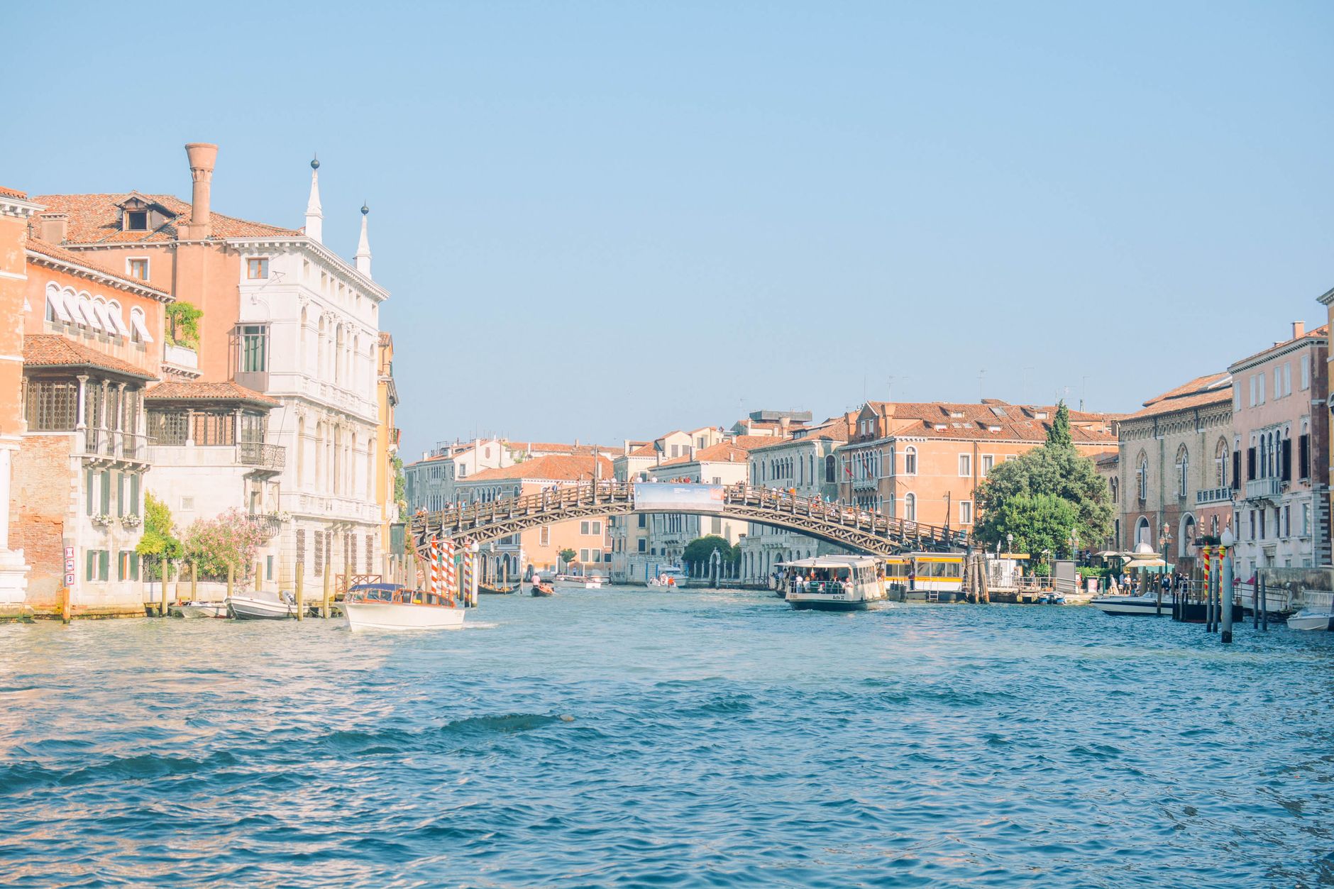 Peaceful summer view of Venice canal with historic architecture and bridge