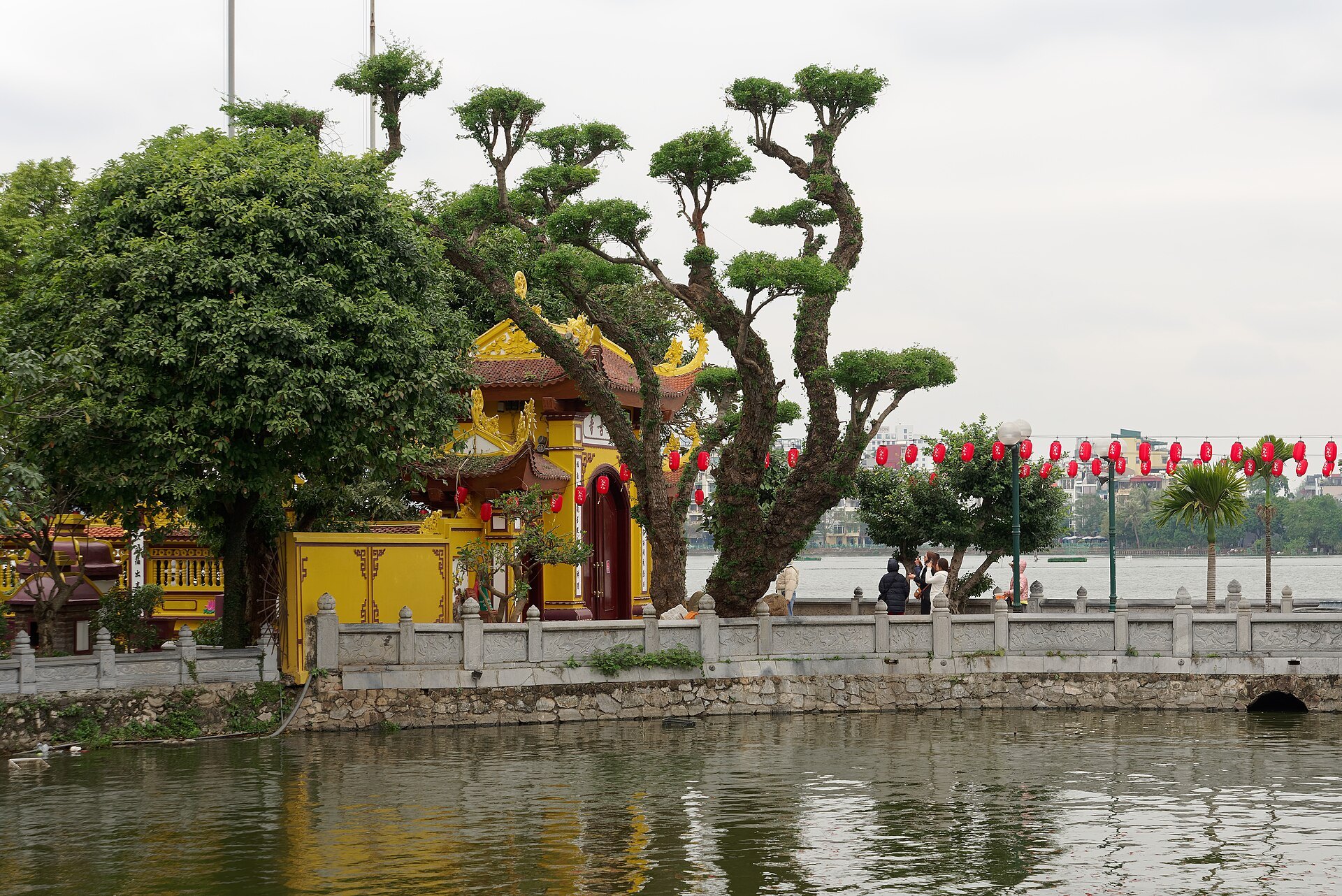 The yellow temple buildings and clipped topiary in the pagoda grounds